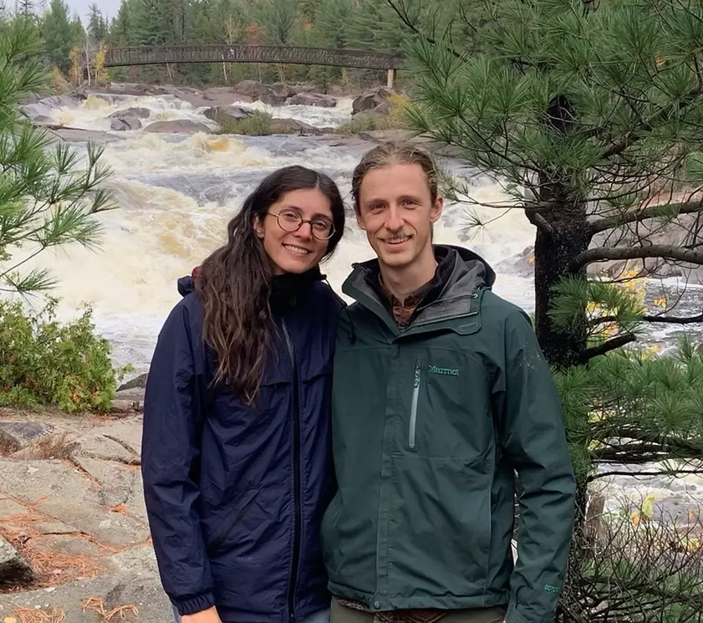 Blair and Liz of Nord in front of a Northern Ontario river