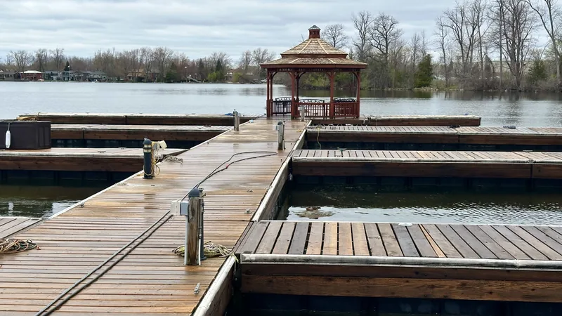 Freshly washed wooden docks and slips at a Simcoe County marina, the gazebo and open water behind