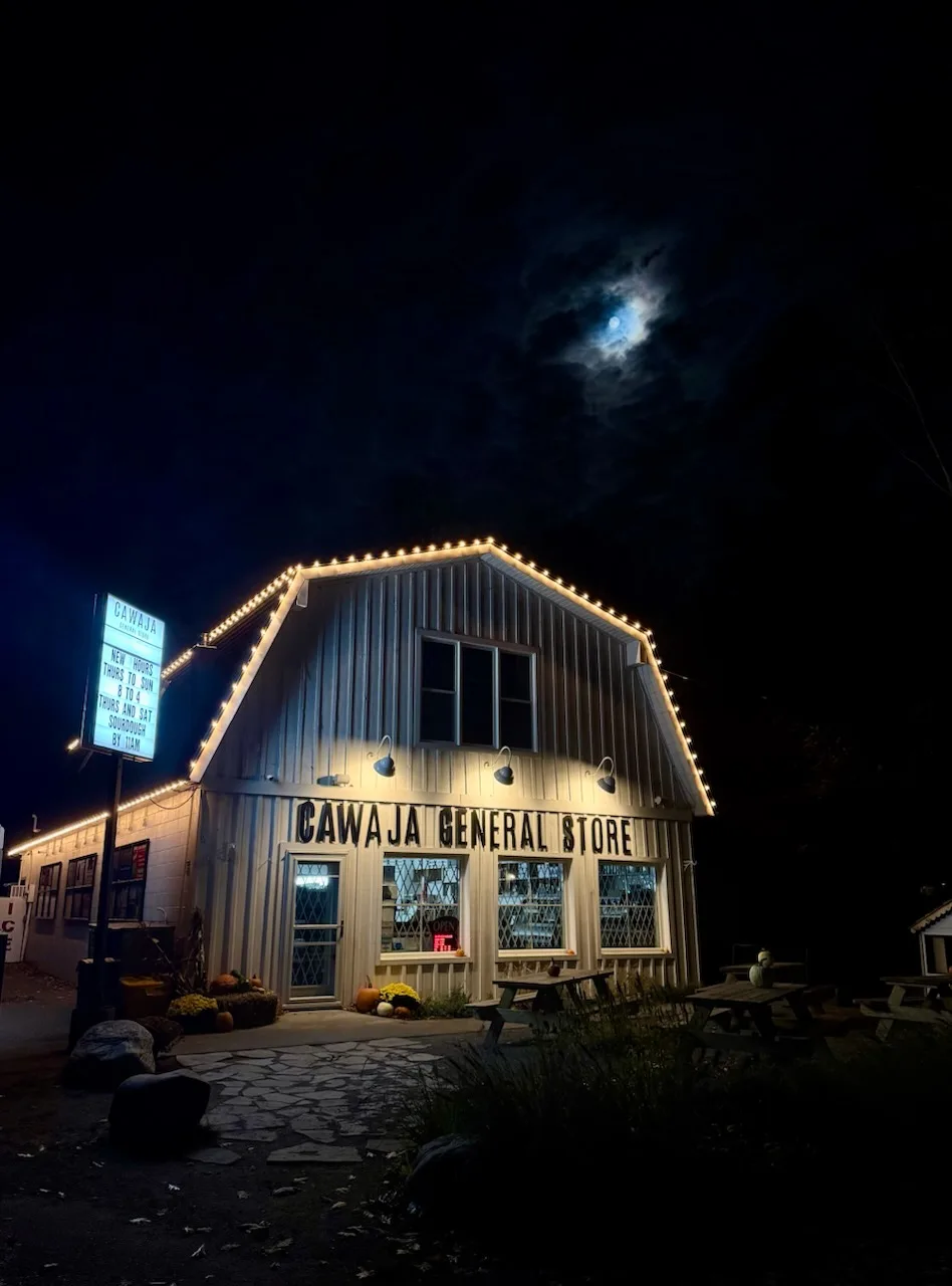 Professional Christmas light installation — Cawaja General Store · a commercial storefront, roofline to gable