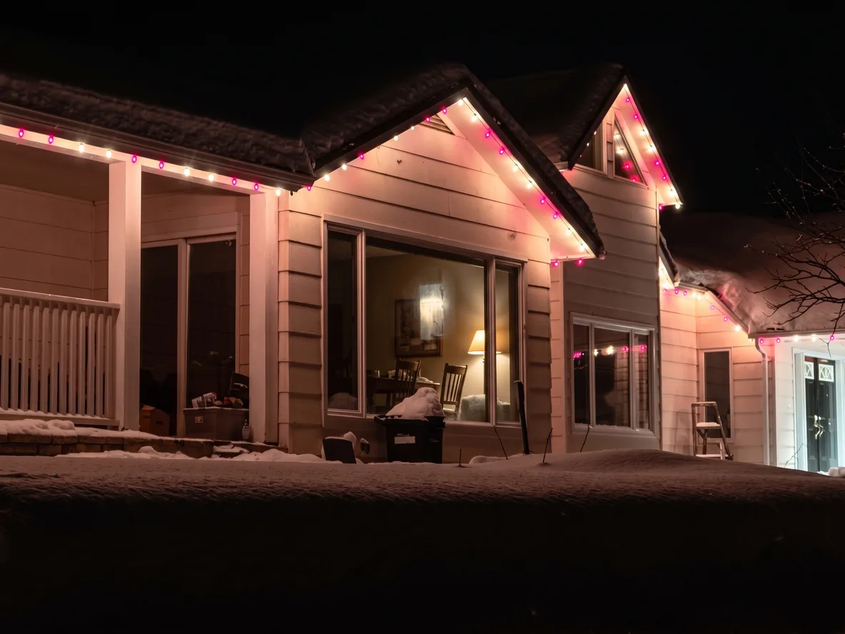 Warm white and red candy-cane Christmas lights along the rooflines of a home in Victoria Harbour — a Nord install