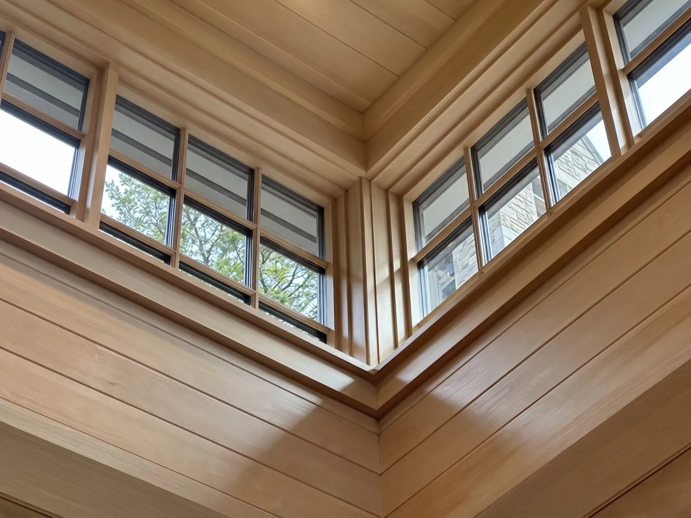 Spotless French-pane clerestory windows in a cedar-panelled room, cleaned by Nord